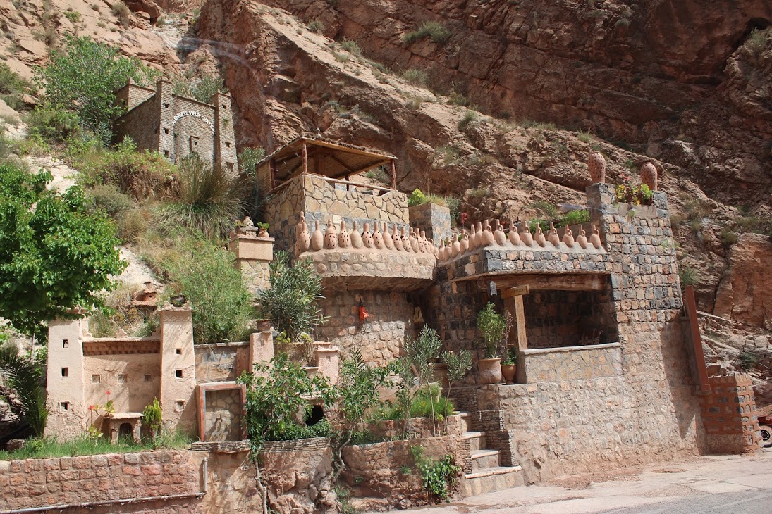 Buildings hugging the wall at the top of the Dades Gorge